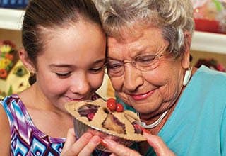 Grandmother and granddaughter share a pie