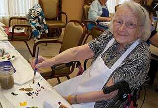 Woman painting at memory care in IN