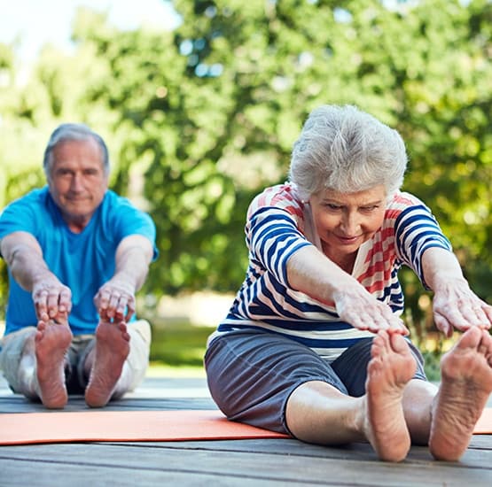 Some of our active residents taking a yoga class here at Greenridge Place in Westminster