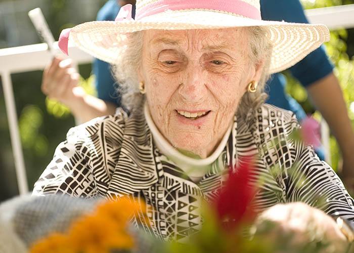 Resident at The Gardens at Park Balboa gardening in the sunshine