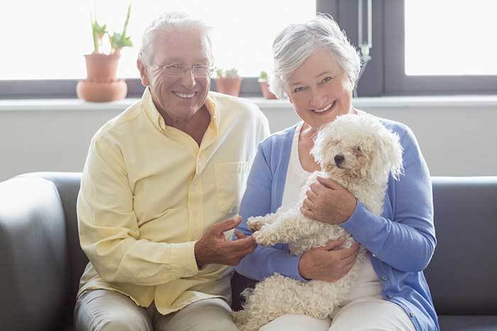 Residents at The Terraces at Park Marino with their poodle friend.