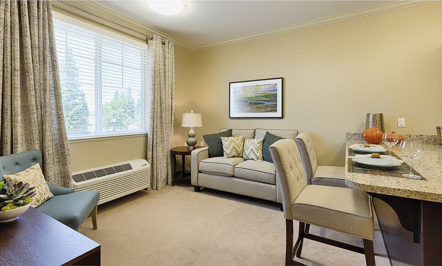 Living room with dining table at Kingston Bay Senior Living in Fresno, California.