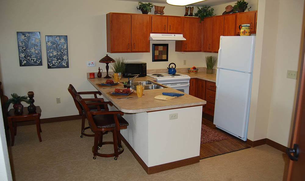 Kitchen with bar dinning area of Flagstone Senior Living in The Dalles, Oregon.