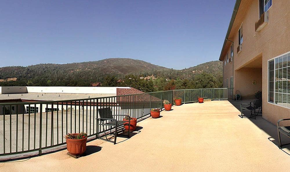 Exterior deck view on a sunny day at Skyline Place Senior Living in Sonora, California. 
