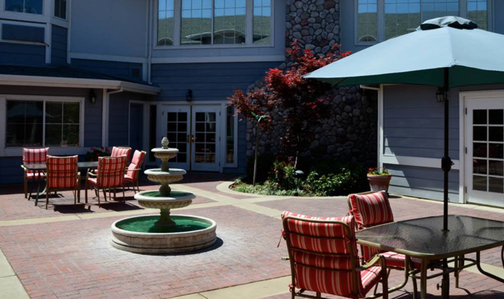 Sunny outside sitting area complete with fountain at Windchime of Chico in Chico, California.