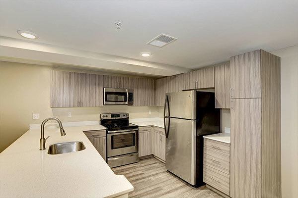 Updated kitchen with hardwood flooring at The Warwick Apartments