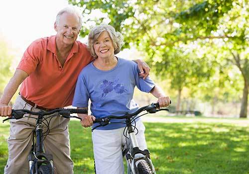 Couple staying healthy and riding their bicycles at Osmond Senior Living in Lindon in Utah.