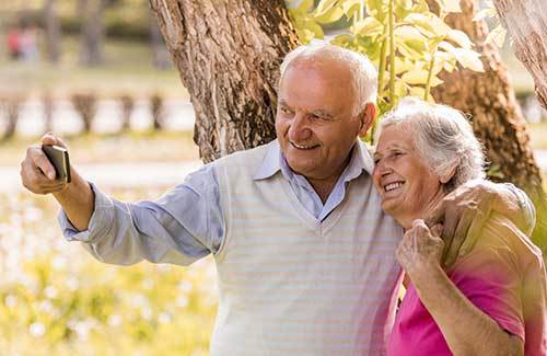 Senior couple smiling for a selfie Osmond Senior Living Memory Care in Salt Lake in Utah.
