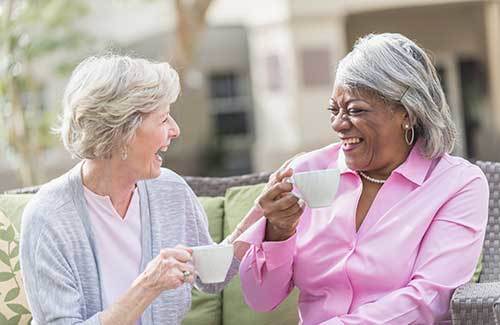 Friends take a photo together at Osmond Senior Living Memory Care in Salt Lake.