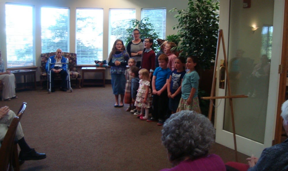 A children's choir performing at Alder Bay Assisted Living