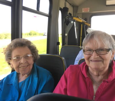 Women socializing on a bus going to Marla Vista Assisted Living and Memory Care