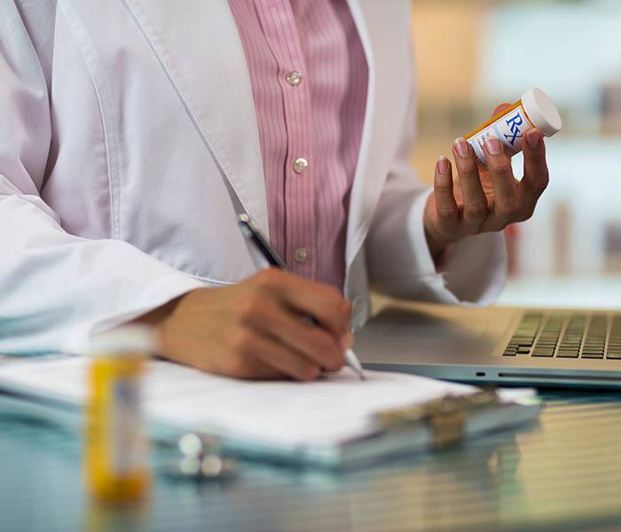 Nurse checking prescriptions