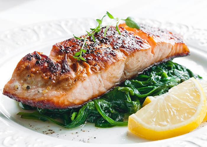 Salmon entree on a bed of greens