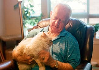 Resident with his pet at senior living in Campbell