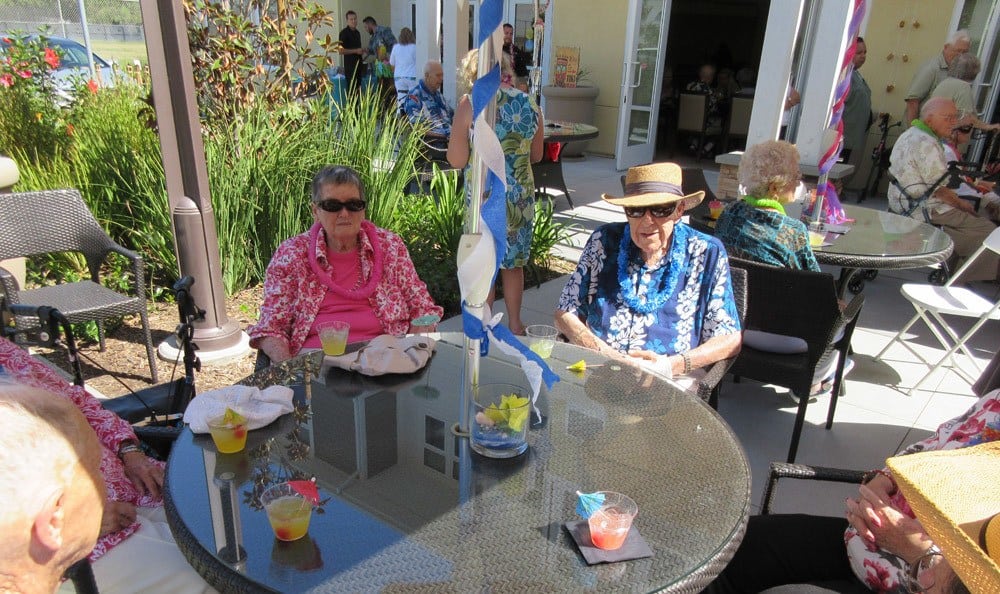 Residents enjoying the patio at Merrill Gardens at Huntington Beach in Huntington Beach, California. 