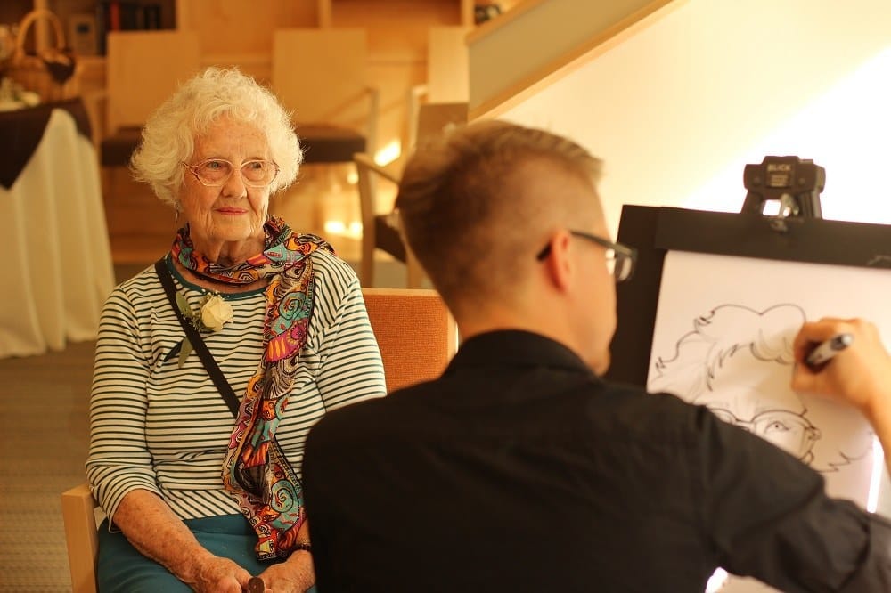 Artist drawing a resident at Merrill Gardens at Ballard in Seattle, Washington. 