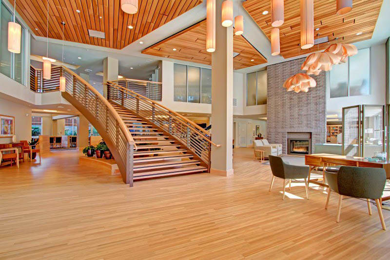 Lobby with a grand staircase at Merrill Gardens at Ballard in Seattle, Washington. 