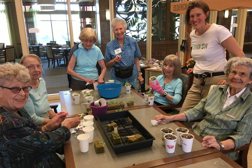 Residents enjoying planting seeds at Merrill Gardens at Burien in Burien, Washington. 
