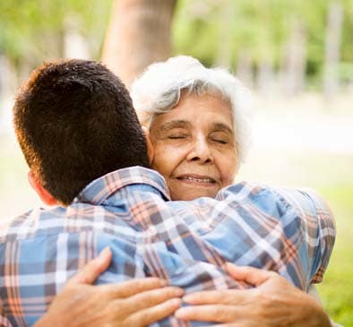 Senior woman hugging adult son in Sumner, WA