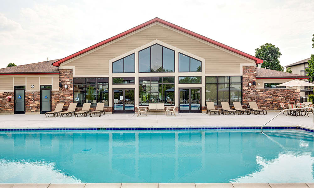 Pool and clubhouse at The Trilogy Apartments