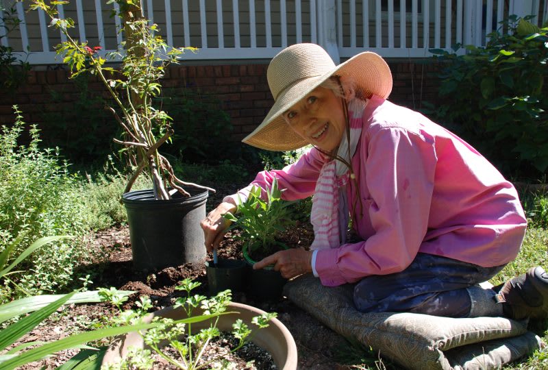 Martha on knees gardening at The Clinton Presbyterian Community