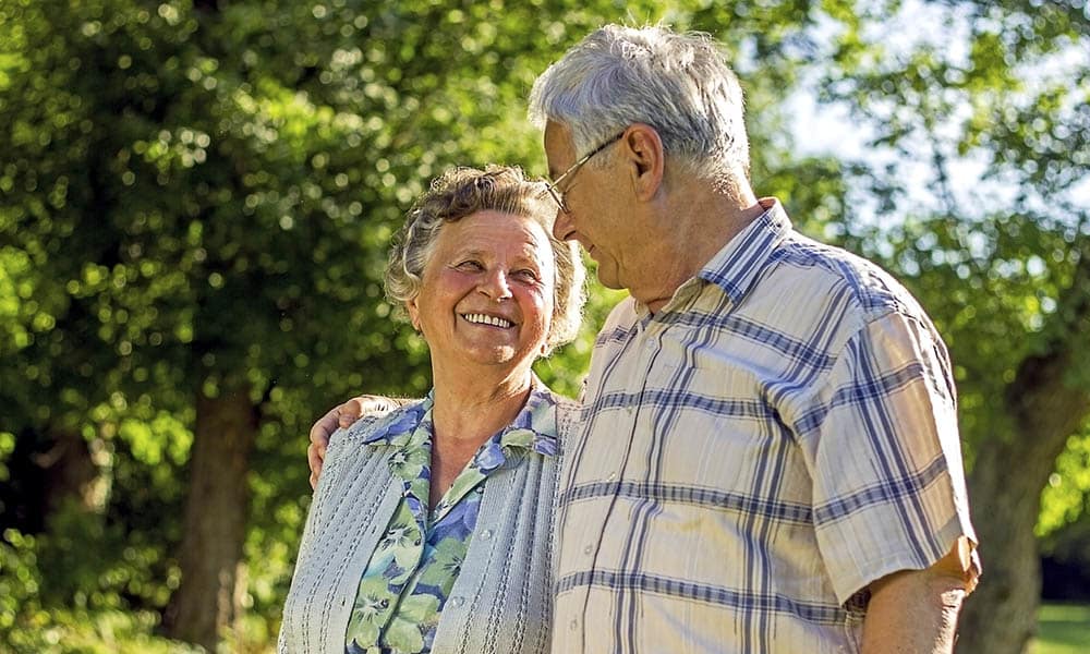 Senior couple walking together outdoors at Presbyterian Communities of South Carolina