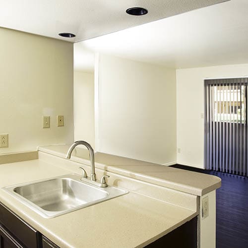 Kitchen and living room at Shadowbrook Apartments in West Valley City, UT