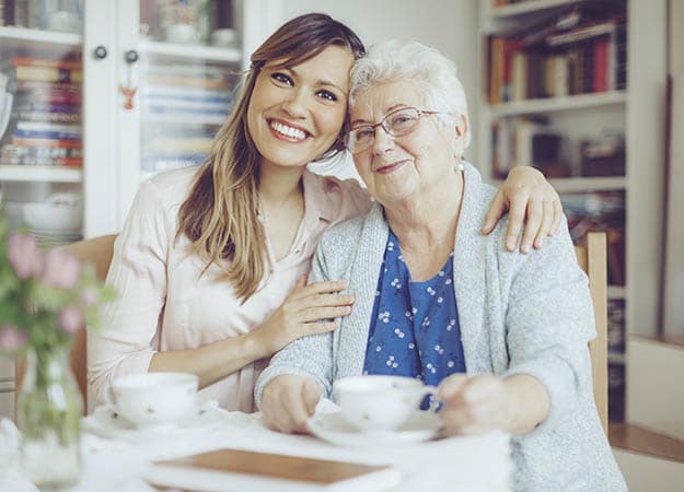 A senior living resident at Avenir Memory Care at Summerlin interacting with her caregiver