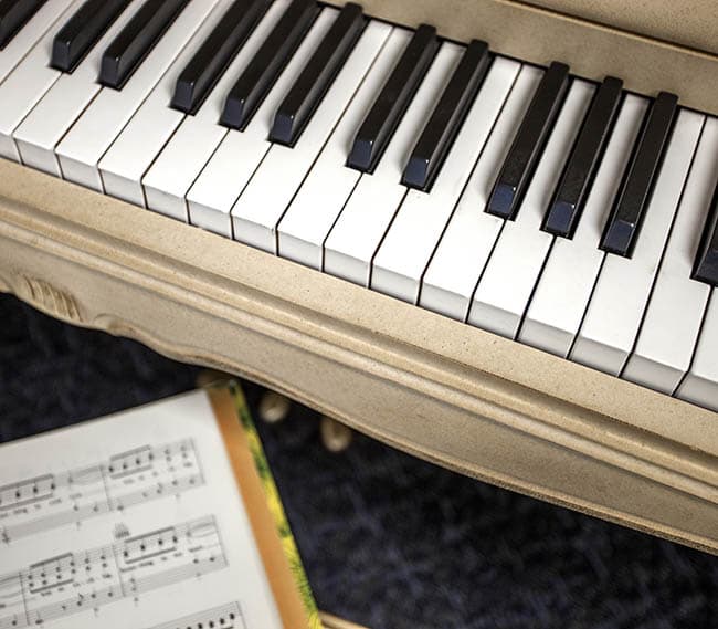 Piano with sheet music at our senior apartments in Ventura