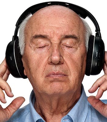 Memory care resident listens to music at DELETED - Pacifica Senior Living