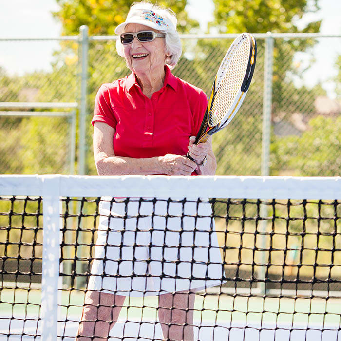 Senior playing tennis at Holly Creek Retirement Community