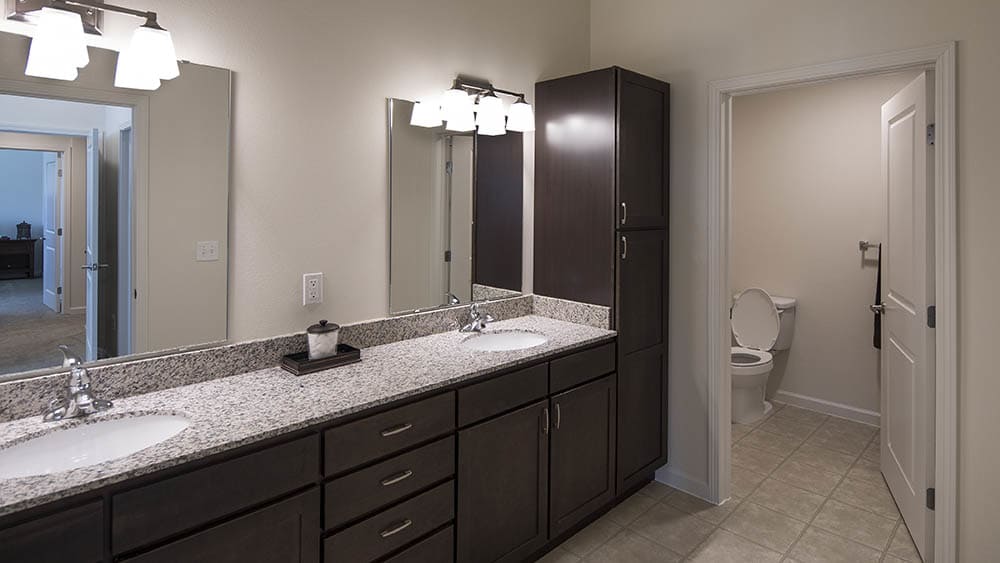 Spacious bathroom with counter space for 2 at Oxford Villa Active Senior Apartments in Wichita, Kansas