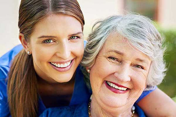 A grandma and nurse share a moment at Morning Pointe of Tuscaloosa