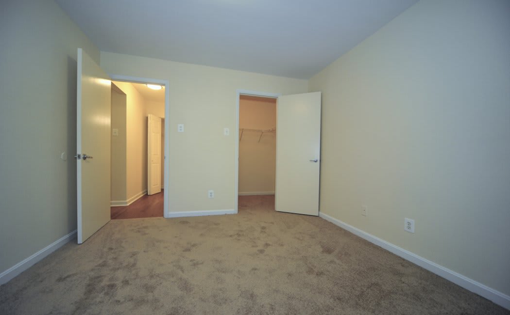 Bedroom and walk-in closet at Washington Apartments in Washington