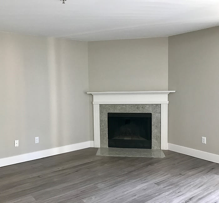 Fireplace and hardwood floors in model apartment home at Chandlers Bay