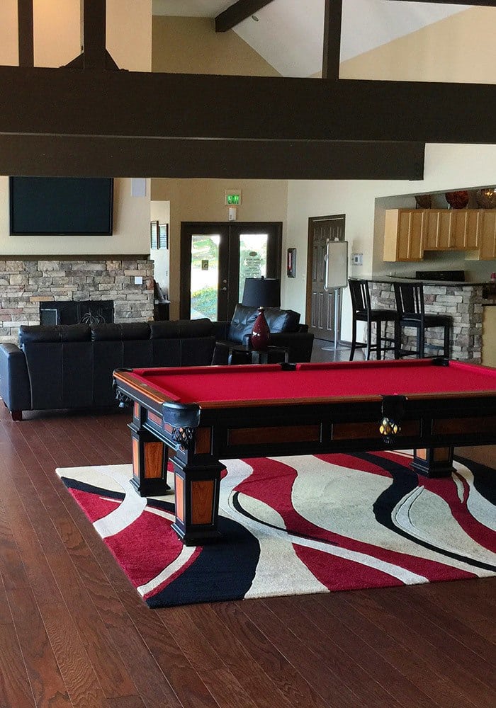 Clubhouse interior showcasing pool table and exposed wood beams in the ceiling at Surprise Lake Village