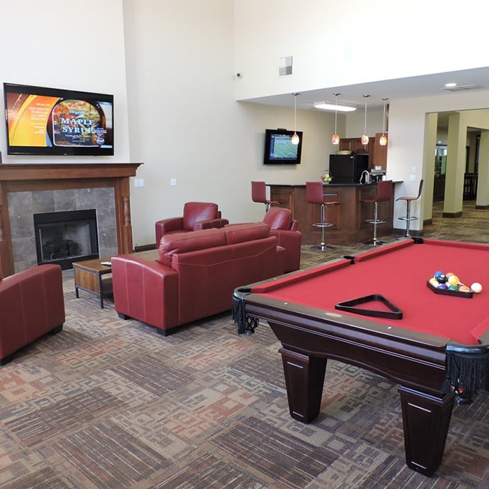 Interior clubhouse view at Village at Seeley Lake, showcasing comfortable seating and billiards table