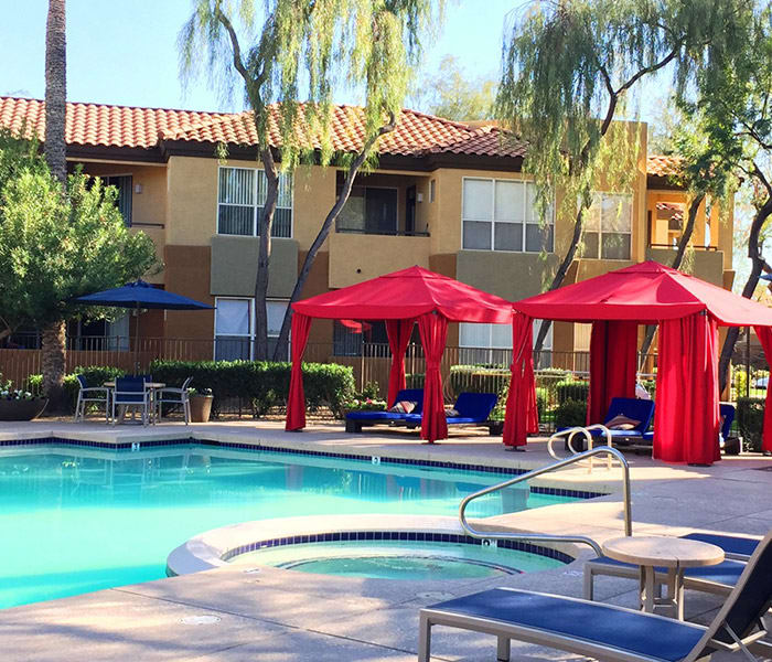 Beautiful swimming pool and shaded cabanas at The Retreat Apartments