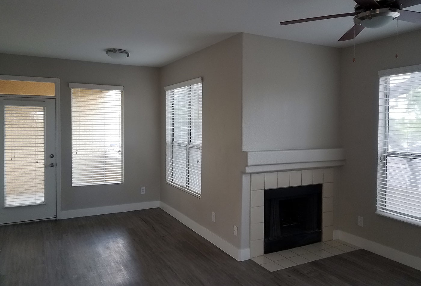 Hardwood floors and fireplace in model home living room at The Retreat Apartments in Phoenix, Arizona