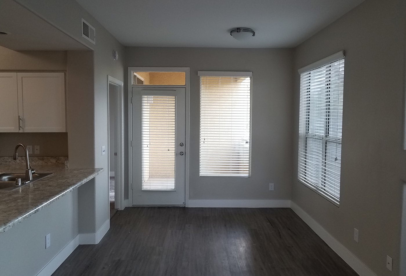 Dining room showcasing hardwood floors in model home at The Retreat Apartments in Phoenix, Arizona