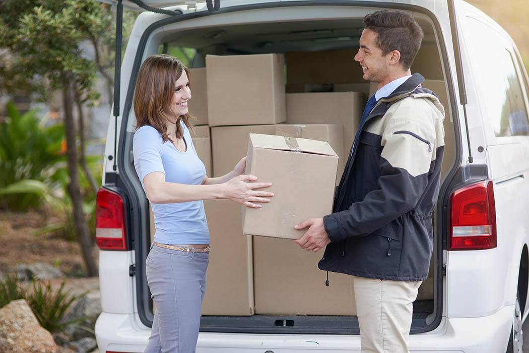 Man helping woman move boxes at Sierra Self Storage in Porterville