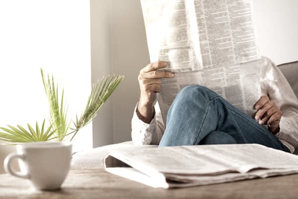 Man reading newspaper at a Clearwater Living community