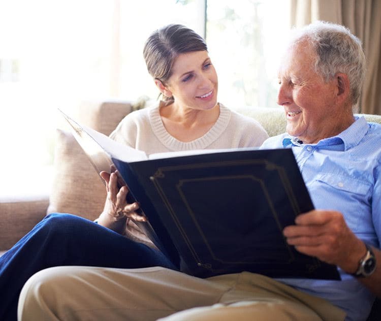 Reading a book in memory care at Creekside on Bardstown in Louisville, KY