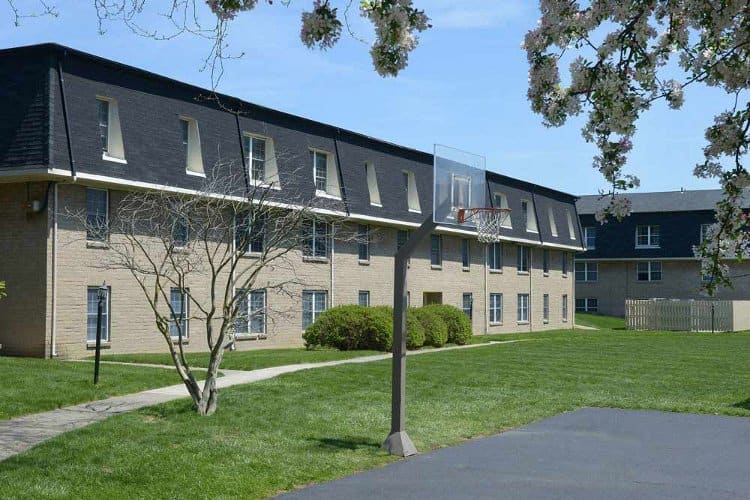 Exterior of apartments and basketball court at The Edge At Arlington