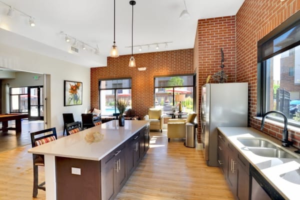 Community clubhouse with seating and kitchen at The Parc at Greenwood Village in Greenwood Village, Colorado