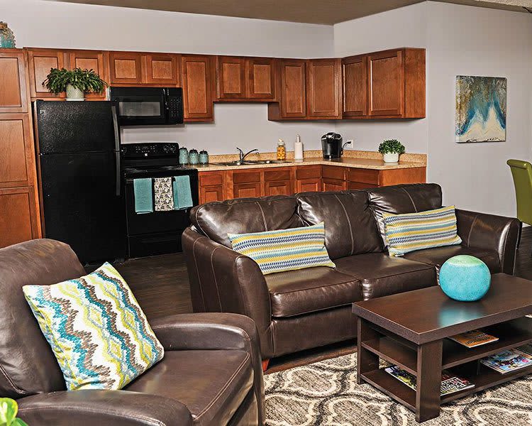 Living room and kitchen view at Webster Manor Apartments home