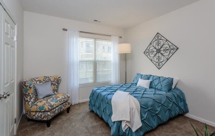 Well decorated bedroom at Auburn Creek Apartments home in Victor