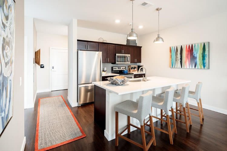 Well-equipped kitchen and breakfast bar at Pinnacle North Apartments home