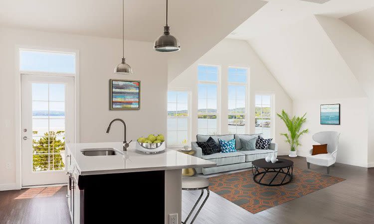 Kitchen island and living room view at Pinnacle North Apartments home