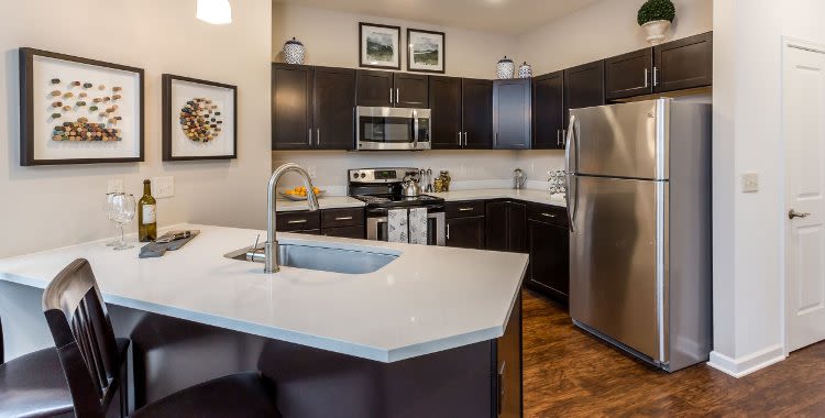 Upgraded kitchen with island at The Links at CenterPointe Townhomes in Canandaigua, NY
